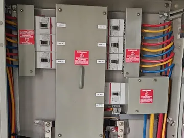 Wired distribution board with breakers and colour-coded cabling