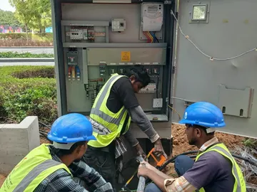 Electrical testing and commissioning in Pakistan: TechLink electricians working on a distribution pillar