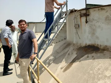 TechLink engineers on a storage tank roof