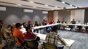 Classroom training session with participants at U-shaped tables