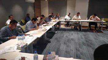 Participants writing during a classroom session